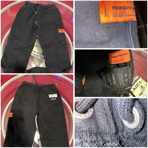 Heron Preston black sweatpants featuring a signature orange logo patch. Size XXS